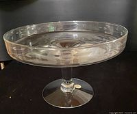 Side view of clear crystal pedestal dish showing etched floral band and stem