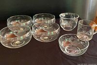 Group of four cereal bowls, two mugs, one small bowl showing etched floral design