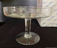 Side view of clear crystal footed cake server on pedestal