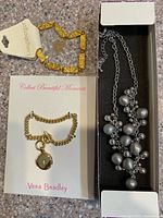 All three jewellery pieces with packaging and tags