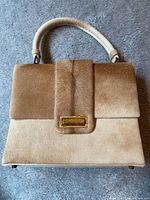Front view showing cowhide texture, flap and hardware
