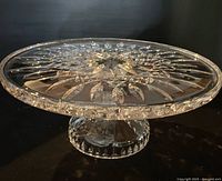 Side view of clear cut crystal pedestal cake plate