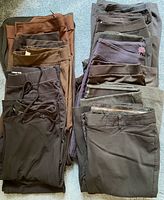 Stacks of twelve women’s pants in assorted dark hues