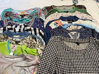 All sixteen tops grouped showing variety of patterns and colours