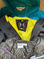 Close view of brand labels: Lands' End, Under Armour YSM, Everlast L