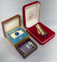 Three vintage Ronson collectible lighters with original boxes shown grouped together.