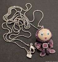 Full view of chain and butterfly pendant showing length and design details.