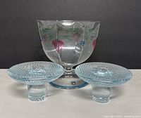 Front view of the candy bowl with painted floral design and two candle holders