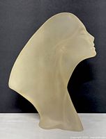 Front angled view of the frosted Lucite sculpture showing female bust profile and form.