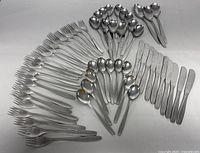 Overhead view of all 55 flatware pieces arranged by type