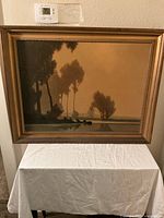 Front view of framed picture showing the lake and boat theme artwork.