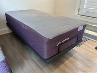 Side view of mattress on adjustable base showing mattress profile and base frame
