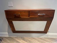 Front view of hallway unit showing two drawers with metal handles above a plexiglass panel framed by wood.
