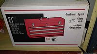 Boxed 3-drawer toolbox with red and black labeling, showing illustration and product details.