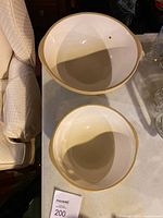 Top view showing large and medium size ceramic mixing bowls with cream interior and beige exterior.