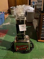 Front view of Vita-Mix Mix'n 1000 commercial blender showing base unit, jar with lid and handle wrapped in plastic.