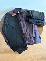All items grouped: Patagonia jacket, J.Crew jeans, three folded Kit & Ace pants