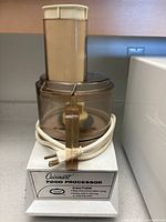 Cuisinart food processor front view showing base, bowl and power cord