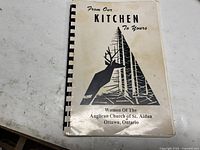 Front cover of the cookbook showing title, church affiliation, and graphic design.