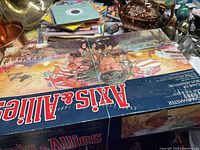 Photo of the closed Axis & Allies box with wartime artwork depicting soldiers and warplanes.