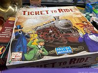 Top view of Ticket to Ride game box with vintage steam locomotive artwork on lid.