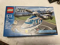 Photo showing the sealed Lego City Police Helicopter set 7741 box with 94 pieces, suitable for ages 5-12.