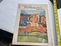 Front cover of the 1935 March issue featuring a woman knitting in a car with two men sitting nearby.