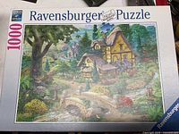 Photo of the Ravensburger Puzzle box showing the cottage image and piece count.