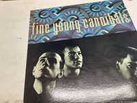 Front cover of Fine Young Cannibals vinyl record sleeve with colorful geometric pattern and band photo.