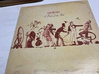 Front side of album cover showing artwork of whimsical characters in sepia tones on cream background.