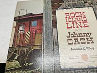 Front cover of the vinyl record album 'Rock Island Line' featuring Johnny Cash and Jeannie C. Riley with train imagery.