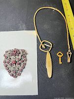Overall lot showing dress clip and fob chain with attachments