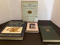 Four hardcover books laid out showing covers and dust jackets
