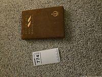 Front cover of brown cloth hardcover with gilt lettering