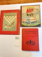 Front covers of all three hardcover books showing titles and cover art