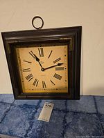 Entire square Elgin wall clock on surface