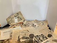 Overview of spread showing numerous newspaper clippings and cartoons