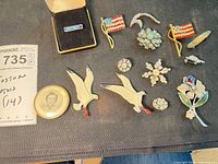 Group shot of all 14 pins on cloth surface
