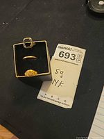 Open ring box showing mount ring without stone and band inside, weight tag visible