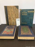 Group shot of four books showing covers and spine designs