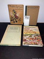 Four hardcover books arranged front covers visible