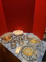 Group shot showing all bowls and tumblers on blue surface