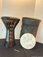 Doumbek body, detached head, padded bag, tuning key overview