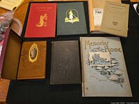 Overall view of seven antique books laid out on table