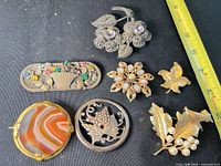 All seven brooches laid out for size and style reference