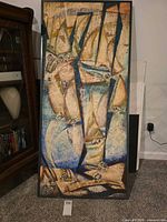 full view of framed painting resting against wall