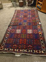 Full view of the Persian geometric rug laid flat
