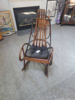 Full view of rustic twig rocking chair with cushion