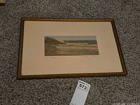 Framed Wallace Nutting seascape on carpet showing full piece