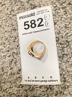 Side profile of gold signet ring on lot card